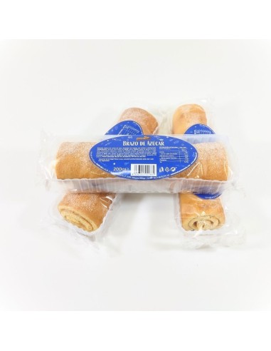 Brazo azucarado Unión Mels, bizcocho enrollado con relleno cremoso y cobertura de azúcar blanca.